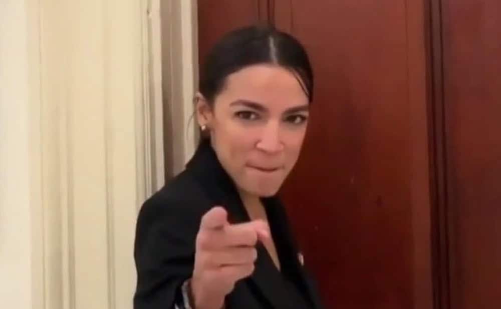 This meme features a photo of Alexandria Ocasio-Cortez, a US politician, pointing directly at the viewer with a stern expression. The text "AOC: 'I'm going to come for you'" appears in the image, implying that she's warning someone of impending consequences. The image is meant to be humorous and intimidating, with AOC's finger pointed aggressively at the viewer.