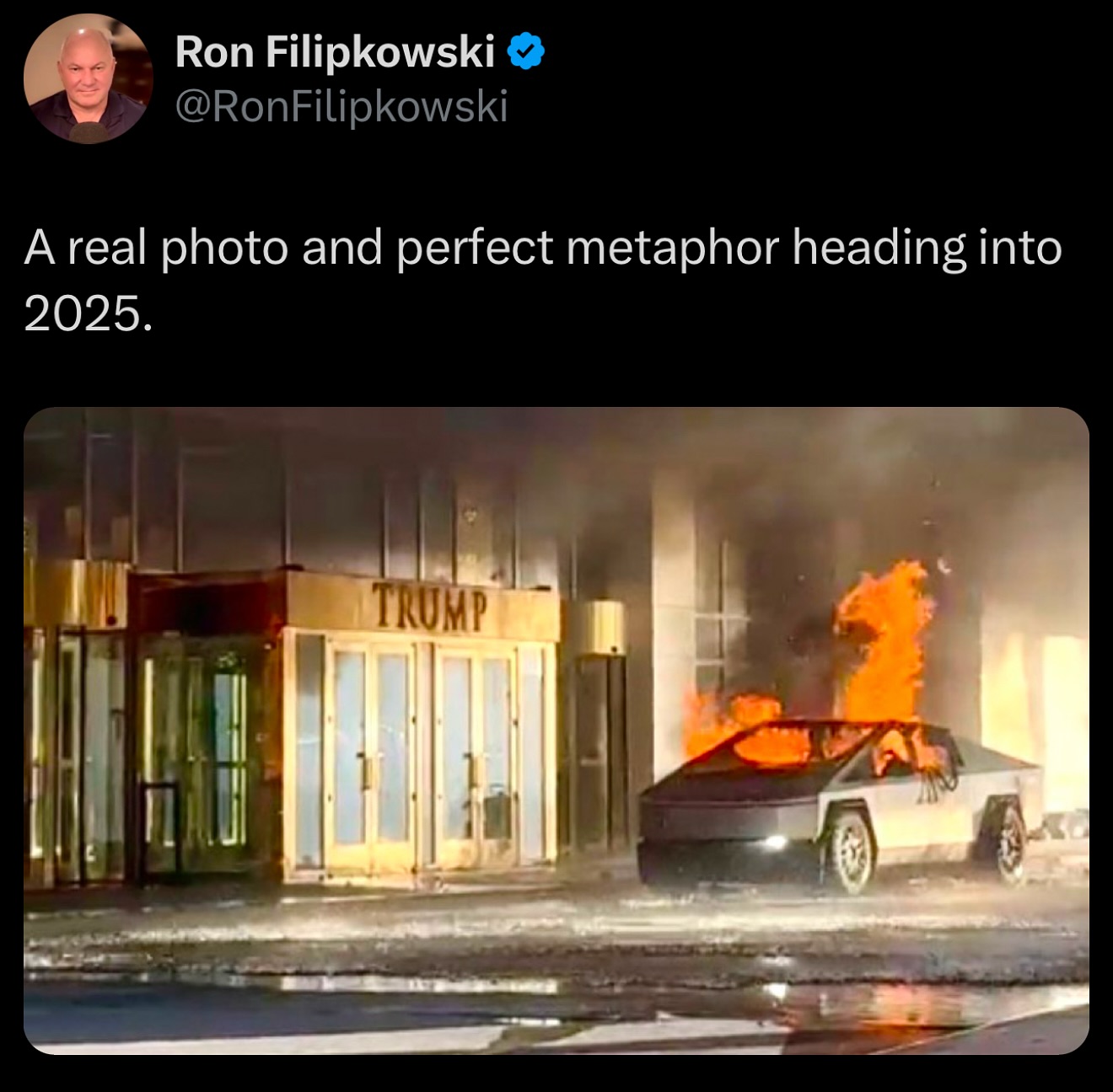 The meme is a humorous prediction of a catastrophic event in 2025. The image depicts a burning, destroyed, and partially collapsed Trump Tower in New York City, with a Tesla Cybertruck (a futuristic electric vehicle) on fire in front of the building. The text "A real photo and perfect metaphor for 2025" is likely a sarcastic commentary on the chaos and destruction that could be expected in the future.