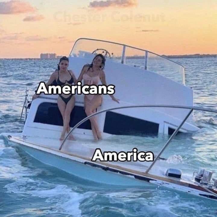 The meme depicts a sinking ship with two women on the deck, labeled as "Americans" and "Europeans". The text "In case of emergency, read the manual" is written on the ship's stern, and the caption "When the boat sinks, blame the Americans" is overlaid on the image. The meme pokes fun at the stereotype that Americans are often blamed for problems that are not their fault.