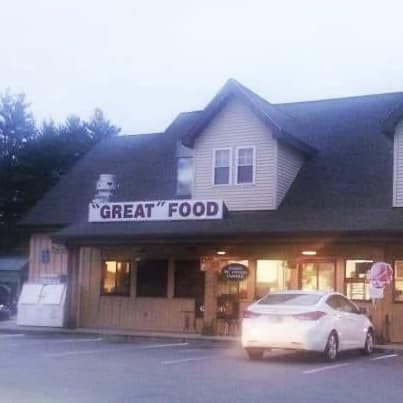 The meme is a photo of a restaurant with a sign that reads "We're not just a restaurant, we're a family" above the entrance, and a sign on the wall that says "We're not just a family, we're a restaurant" in response. The first sign is a play on the common phrase "we're not just a [industry], we're a [family]", but the second sign subverts this expectation by saying the opposite. The humor comes from the unexpected twist on the usual phrase.