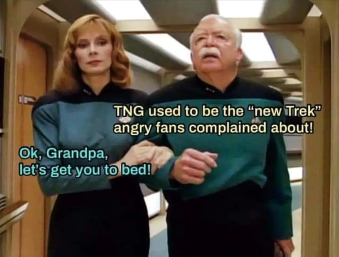 This meme is a humorous image of two Star Trek: The Next Generation characters, Deanna Troi and William Riker, from the show's "The Best of Both Worlds, Part II" episode. The text "TNG used to be the 'new' Trek, now it's TNG" is overlaid on the image, implying that the show has aged and is no longer considered "new". The caption "TNG used to be the 'new' Trek, now it's TNG" is a play on words, referencing the show's original title and the current state of the franchise.