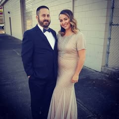 Here's an analysis of the image based on the frameworks requested, only addressing those that apply and offering insights where relevant. **Visual Description** The image depicts a man and a woman standing next to eac...