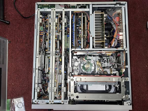 Okay, here's an analysis of the image of the open computer tower, broken down into sections, focusing on the requested theoretical frameworks. I will include only sections where the framework seems meaningfully applic...