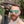 Okay, let's analyze the image, keeping in mind its low resolution makes detailed interpretations speculative. **Visual Description** The image shows a close-up of a person wearing sunglasses and a cap. The overall qua...