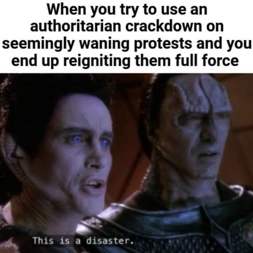 This meme is a humorous image of a character from the Star Trek franchise, Captain Jean-Luc Picard, with a shocked expression. The text above the image reads "When you try to use an authoritarian crackdown on peacefully protesting citizens and it ends in disaster". The text below the image reads "In 2 hours, we will be at maximum capacity. In 1 hour, we will be at maximum capacity. In 30 minutes, we will be at...". The image is a play on the Star Trek: The Next Generation episode "The Battle of Trafalgar" where Captain Picard is forced to surrender his ship to the enemy.