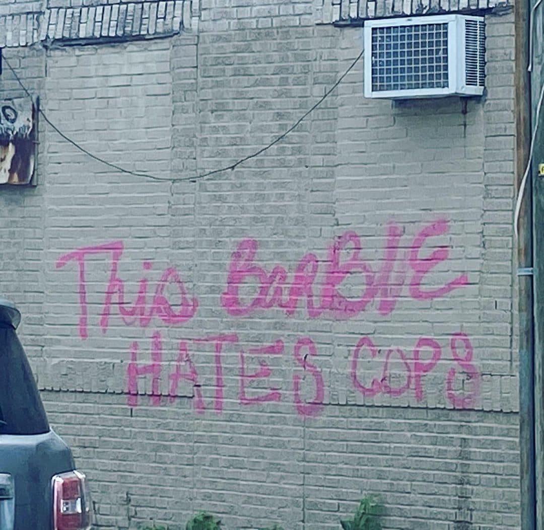 This meme is a humorous image of a 1980s-style "Barbie" doll with the words "This Barbie Hates Cops" written on it, implying that the doll has a rebellious and anti-authority personality. The image is likely meant to be ironic or satirical, poking fun at the idea of a "tough" or "edgy" Barbie doll. The text is written in a bold, graffiti-style font to emphasize the doll's "rebellious" personality.