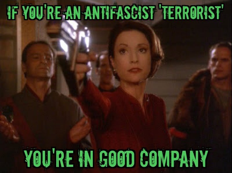 The meme is a play on the phrase "I'm not a terrorist, I'm a freedom fighter" and replaces the word "freedom" with "fascist". The image is a screenshot from the 1997 movie "The Fifth Element", featuring a character saying "I'm not a terrorist, I'm a fascist... I'm a fascist... I'm a fascist" in a humorous and ironic way.