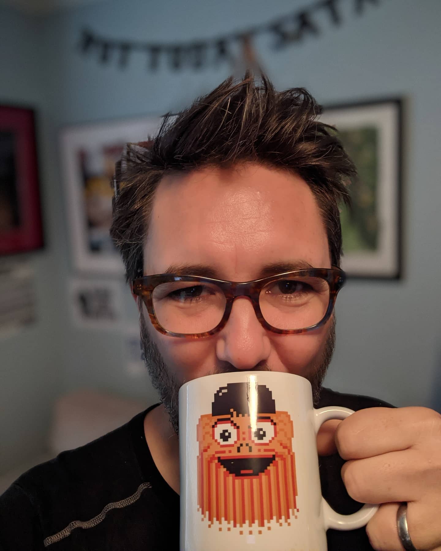 The meme features a man with a shaggy beard and wild hair, holding a mug with a pixelated image of a bearded man's face. The text "I can see you're not here to talk about my beard" appears above the image. The meme is likely used to express a sense of irony or humor when someone is trying to talk about something else, but the other person is still focused on their own interests.