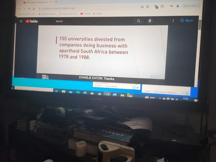 The meme is a screenshot of a YouTube video's description box. The text in the box reads: "155 universities divested from companies doing business with apartheid South Africa between 1978 and 1988."