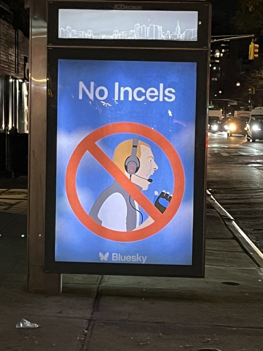 The meme is a humorous image that pokes fun at a common stereotype about tech support. The image shows a sign at a bus stop that reads "No Incels" (a reference to the internet slang term "incel," which refers to a person who is socially isolated and has a strong sense of entitlement) and features a cartoon image of a man wearing a headset and a "no" symbol. The sign is meant to be ironic and humorous, implying that the bus stop is so safe that even the most socially challenged individuals can't even get a job as a phone operator.