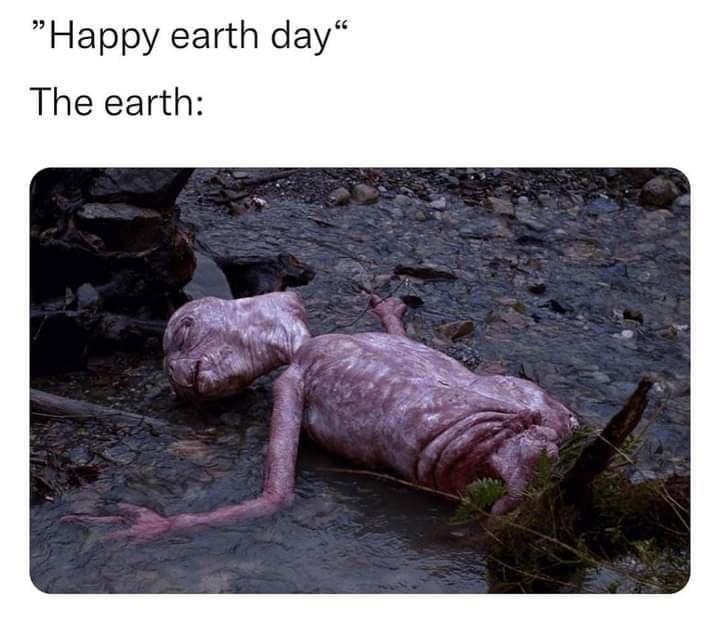 This meme is a humorous take on the traditional "Happy Earth Day" greeting. The image depicts a grotesque, zombie-like creature emerging from a muddy, polluted environment, with the text "Happy Earth Day" above it. The juxtaposition of the cheerful greeting with the horrific, polluted creature is meant to be ironic and humorous.