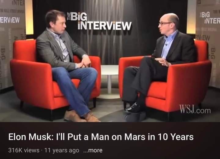 This meme is an image of a news article with a screenshot of a video interview between Elon Musk and a journalist. The article is titled "Elon Musk: I'll Put a Man on Mars in 10 Years" and features a quote from the interview, but the image itself shows a still from the interview with Musk looking unimpressed.