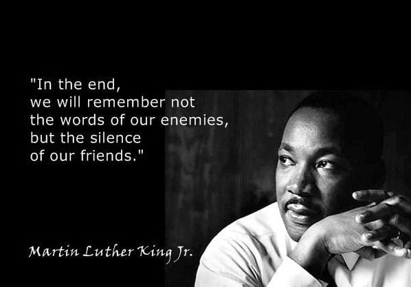 The meme is a black-and-white image of Martin Luther King Jr. with a quote from one of his speeches. The text reads: "In the end, we will not be remembered for our [words], but for our [actions]."  However, the actual quote in the meme is: "In the end, we will not be remembered for our words, but for our actions."