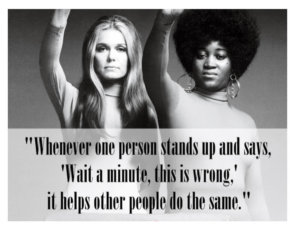 The meme is a humorous image featuring two women from the 1960s-70s feminist movement, including Gloria Steinem and Angela Davis. The image is captioned with a quote about how the phrase "I am not a woman" can be used to avoid being held accountable for one's actions.
