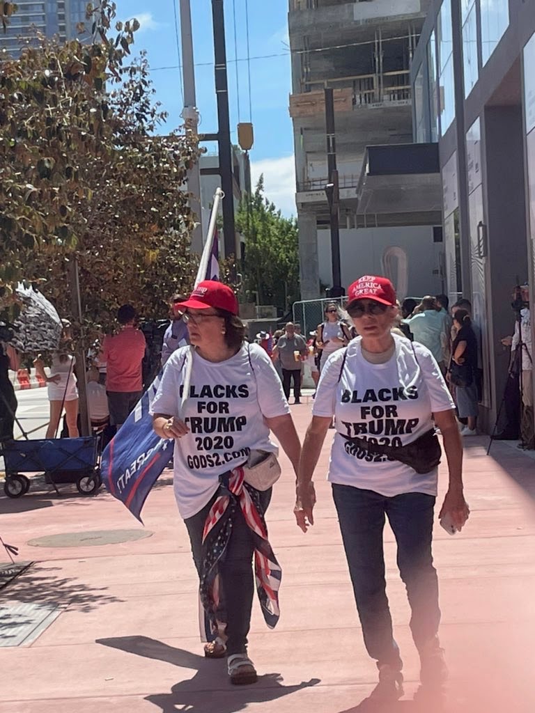 This meme is an image of two elderly women wearing "Make America Great Again" hats and "Blacks for Trump" t-shirts, with one of them holding a "Blacks for Trump" sign. The text on their shirts reads "Blacks for Trump 2020" and "Blacks for Trump", and the image is likely intended to be humorous or satirical. The meme is likely poking fun at the idea that there is a significant number of black people who support Trump, which is not widely accepted as true.