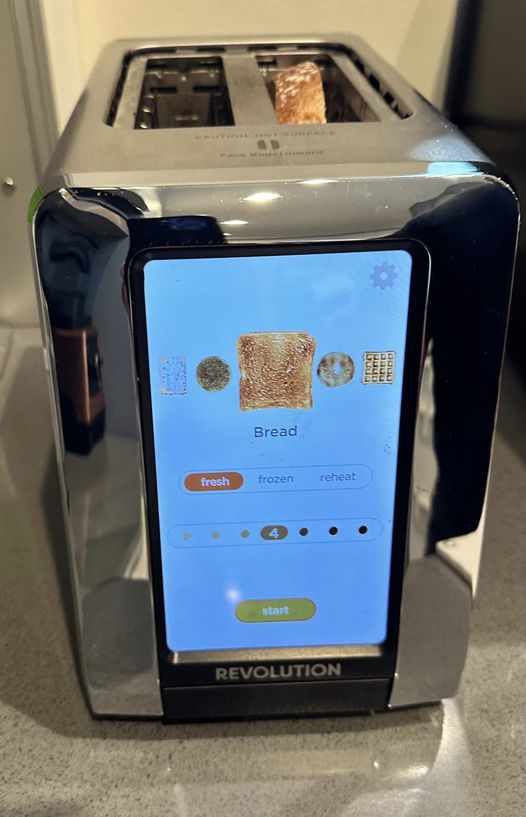 This meme is a humorous image of a toaster with a screen displaying a "Toast Settings" menu. The menu lists various options, including "Toast Level", "Toast Color", and "Toast Sound", but the most interesting option is "Toast Personality" with a dropdown list of "Sarcastic", "Bitter", and "Angry".