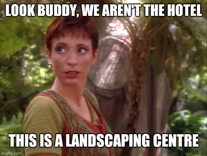 This meme is a humorous take on the classic "I'm not a [insert profession], I'm a [different profession]" joke. The image features a still from the movie "Star Trek: The Next Generation" of a character named Deanna Troi, who is a counselor and the ship's emotional intelligence expert. The text overlayed on the image reads "I'm not a doctor, I'm a bartender" but is modified to say "I'm not a doctor, I'm a landscaper" and then "I'm not a doctor, I'm a hotel".