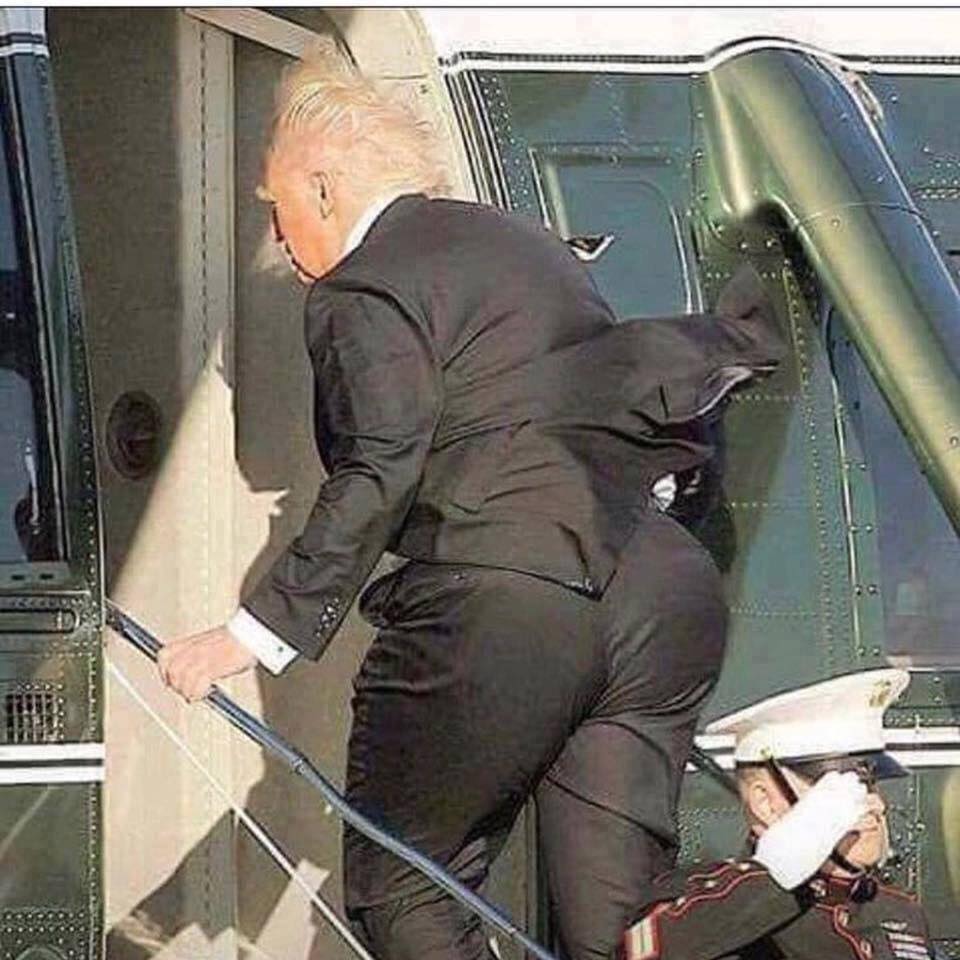 This meme features a photograph of Donald Trump, the 45th President of the United States, descending the stairs from an airplane. The image is captioned "Donald Trump's ass" and has been edited to exaggerate the size of his buttocks, making them appear larger than his torso. The meme is likely intended to be humorous or satirical, commenting on Trump's physical appearance or his perceived lack of dignity.