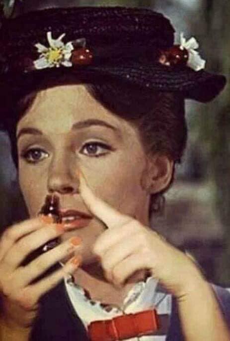 The meme is a screenshot from the 1964 film "Mary Poppins" featuring Julie Andrews as the titular character. The image shows Mary Poppins with a spoonful of medicine in her mouth, with the text "when you know the doctor is going to give you a shot" overlaid on top. The meme is likely being used to express skepticism or annoyance at a situation where a medical professional is about to administer a painful or unpleasant treatment.