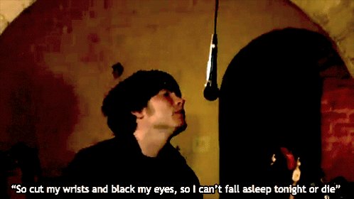 This meme is a screenshot from the TV show "The Office" featuring Jim Halpert, played by actor John Krasinski. The image shows Jim in a dimly lit room, looking directly at the camera with a mischievous expression. The text at the top of the image reads: "That's how I became a monster" and at the bottom: "So I went to the woods and I followed the road for a while, and then I heard a voice calling from inside my head saying 'there's something out there that doesn’t want us to have it'".