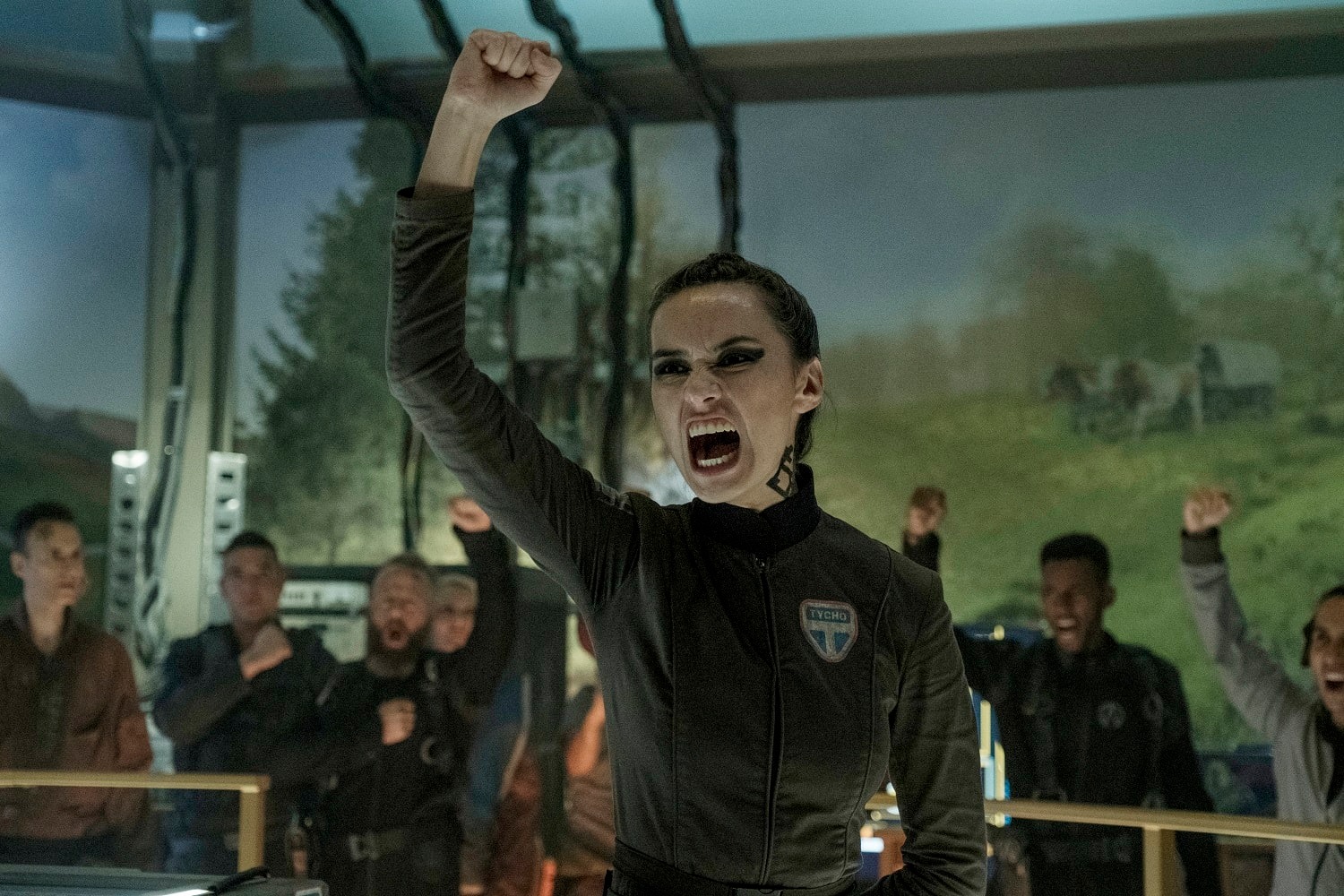 This meme features a photo of a woman from the TV show "Orphan Black" with her arms raised in triumph. The image is captioned "when you finally get the last slice of pizza" and is likely used to express excitement or triumph in a humorous way.