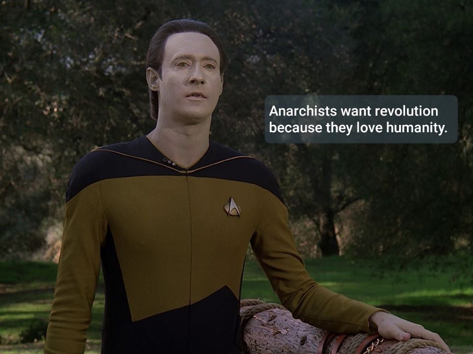 This meme features a screenshot from the TV show Star Trek: The Next Generation, with the character Data (played by Brent Spiner) looking puzzled. The text overlayed on the image reads: "Anarchists want to overthrow the government, but they also want to keep their smartphones and Netflix subscriptions. Anarchists want to live in a world without governments, but they also want to be able to use their iPhones and watch their favorite TV shows."