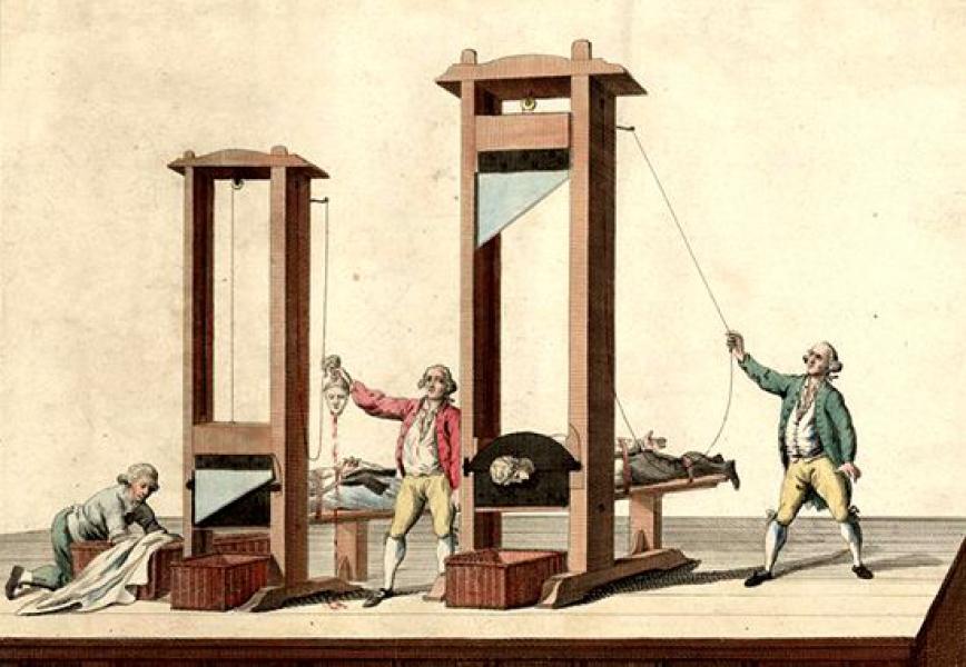 The meme features an image of the infamous French Revolution's guillotine, a device used to behead people. The image is captioned "When you're trying to have a peaceful dinner but your family's politics are still on the table". The meme is likely referencing the historical use of the guillotine as a symbol of the French Revolution's violent and bloody history.