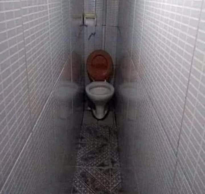This meme is a darkly humorous image of a narrow, dimly lit toilet stall with a toilet in the center. The text "I'm not arguing, I'm just explaining why I'm right" appears above the toilet, implying that the person is so convinced of their own rightness that they're willing to argue from a toilet stall. The image is likely meant to be humorous and ironic, poking fun at the idea of someone being so stubborn that they're willing to argue from a place that's typically used for, well, not arguing.