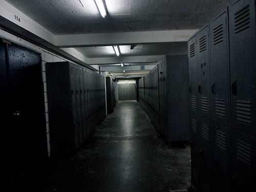 The meme is an image of a dark and empty hallway in a school, with rows of lockers lining the walls. The text "I'm not arguing, I'm just explaining why I'm right" is written in a bold, white font above the lockers. The image is meant to be humorous, implying that someone is being overly defensive or argumentative.