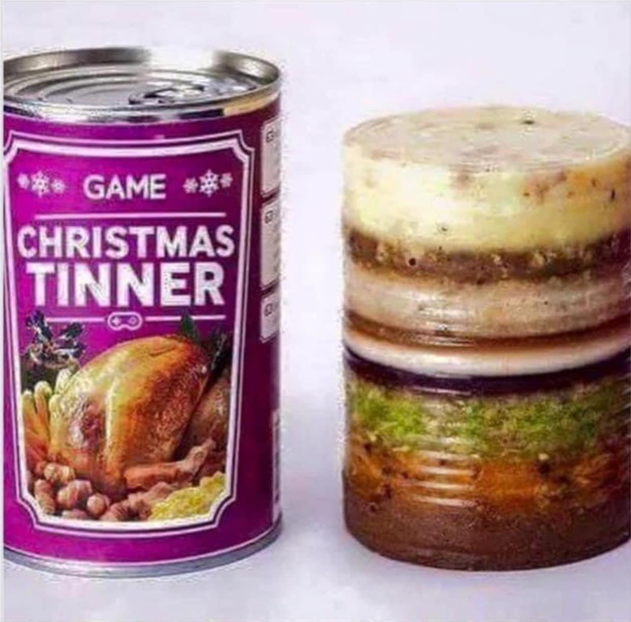 This meme is a play on the idea of a "Christmas dinner" being a traditional British meal, but in this case, it's a canned product called "Christmas Dinner in a Tin" (or "Christmas Tinner" in some versions). The image likely shows a can with this label, and the joke is that the contents of the can are a messy, unappetizing mixture of food, rather than a traditional, well-cooked meal. The text on the can is likely "Game Christmas Tinner" or something similar, with a picture of a cooked chicken or other festive food.