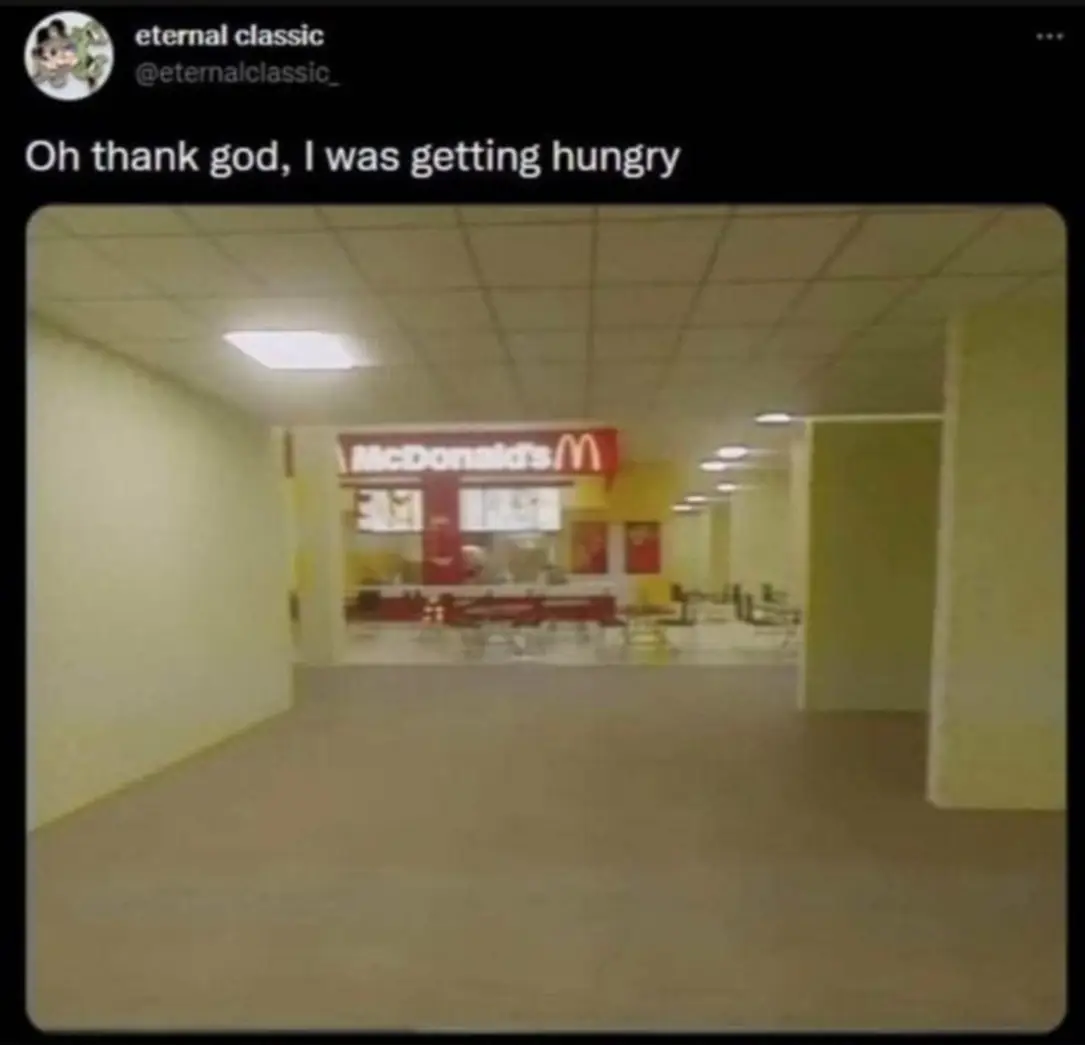 This meme is a humorous image of a nearly empty, dimly lit, and seemingly abandoned McDonald's restaurant. The image is captioned with the text: "Oh thank god, I was getting hungry." The meme is likely intended to be ironic, poking fun at the idea of being relieved to be in a place that is often associated with food, but finding it empty and uninviting.