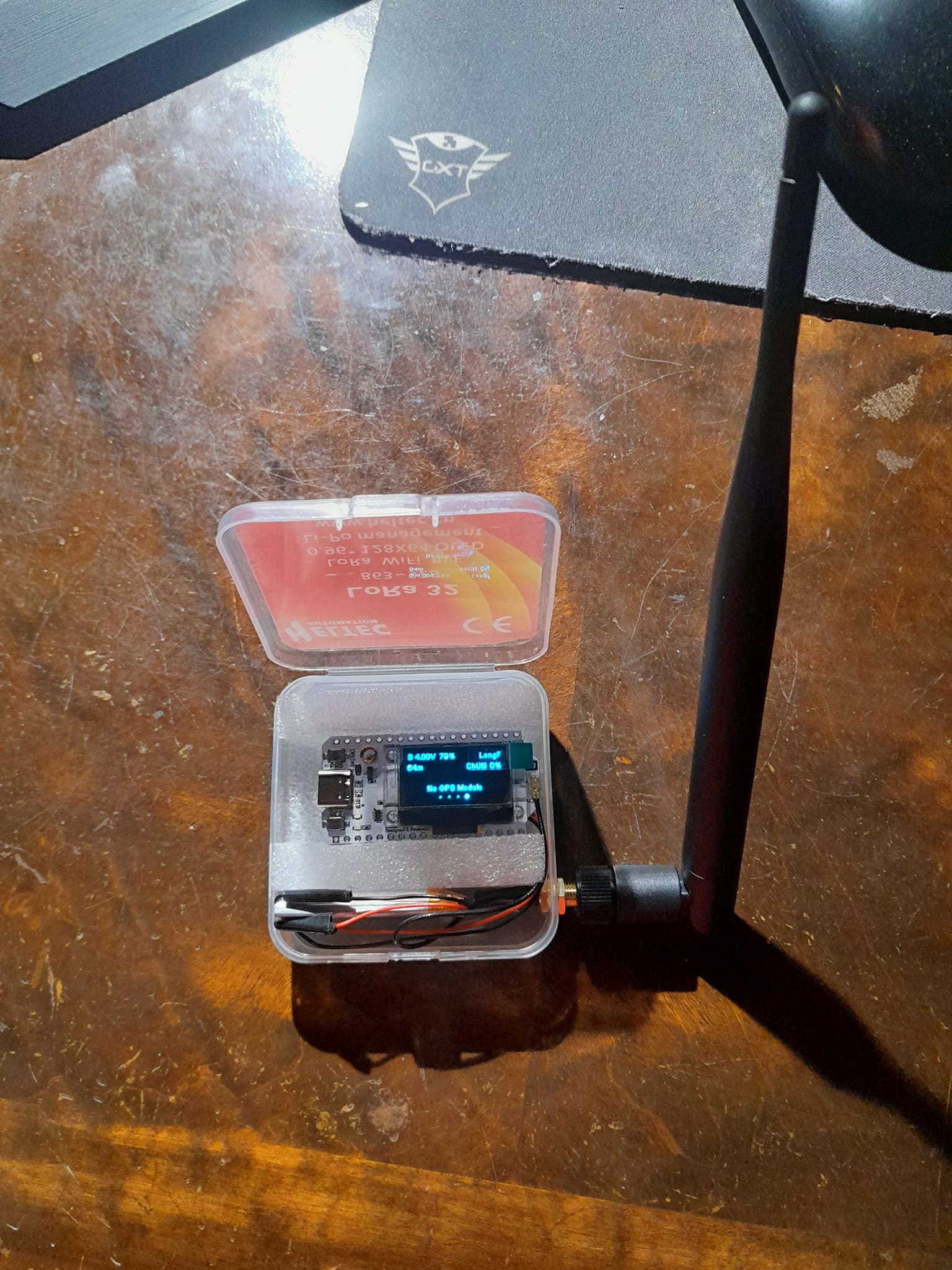 The meme is a picture of a small, portable Wi-Fi router, often referred to as a "pocket router" or "pocket Wi-Fi". The image is captioned "When you're on a plane and your Wi-Fi is 2G". The text suggests that the router is so small and portable that it can be easily carried on a plane, and the Wi-Fi is so slow that it's only 2G (a type of slow internet connection).