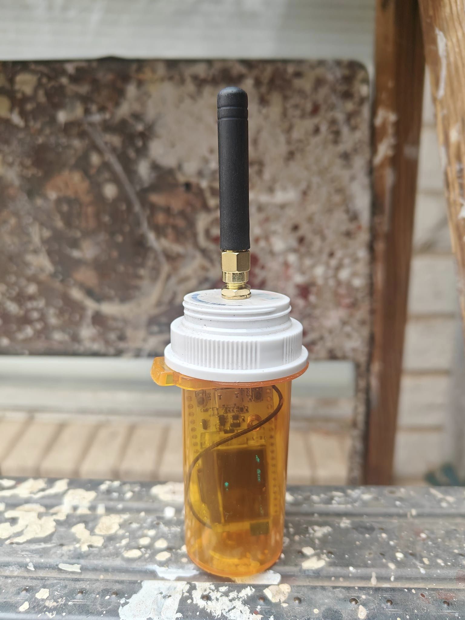 This meme is an image of a small, homemade robot (the "Drone") built inside a pill bottle. The text in the image reads: "I built a drone in a pill bottle. It's not a thing, it's a thing in a thing."