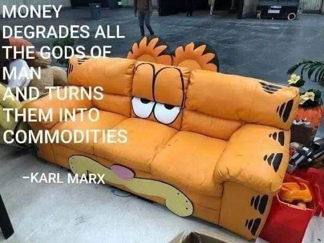 This meme features a photo of a couch shaped like Garfield, the cartoon cat. The text "MONEY DEGRADES ALL THE GODS OF MAN AND TURNS THEM INTO COMMODITIES" is overlaid on the image, with a quote from Karl Marx. The image is humorous because it juxtaposes a seemingly innocent, childlike object (a Garfield-themed couch) with a quote about the corrupting influence of wealth.