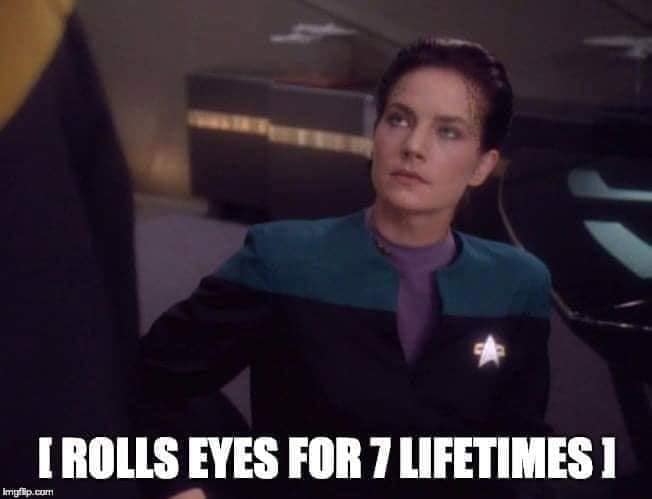 This meme is a screenshot from the TV show Star Trek: The Next Generation, featuring the character Deanna Troi (played by actress Troi) with a concerned expression. The text overlayed on the image reads: "I ROLL EYES FOR 7 LIFETIMES". The meme is likely humorous because it takes a serious and emotional moment from the show and turns it into a humorous, exaggerated expression of annoyance or frustration.