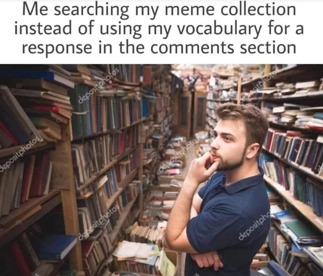 This meme is a photo of a person standing in a crowded, disorganized library or bookstore. The person is surrounded by stacks of books and has a thoughtful, confused expression. The text above the image reads, "Me searching my meme collection instead of using my vocabulary for a response in the comments section."