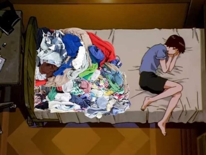 The meme is a screenshot from the anime "K-On!" showing the character Azumi Yumi sitting on a bed surrounded by a massive pile of clothes. The text "I'm not lazy, I'm just on energy-saving mode" is written above the image. The meme is humorous because it exaggerates the common experience of feeling overwhelmed by a messy room, but in a more humorous and relatable way.