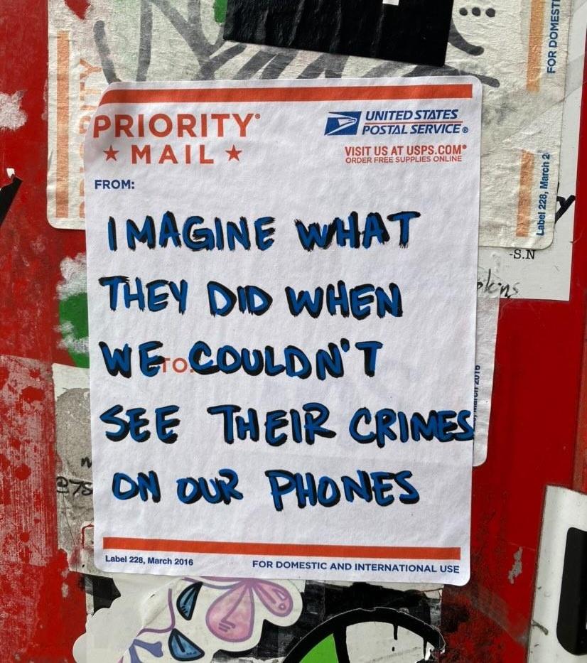 The meme is a screenshot of a Post-It note with a handwritten message on a white background. The text reads: "Imagine what they did when we couldn't see their crimes on our phones."