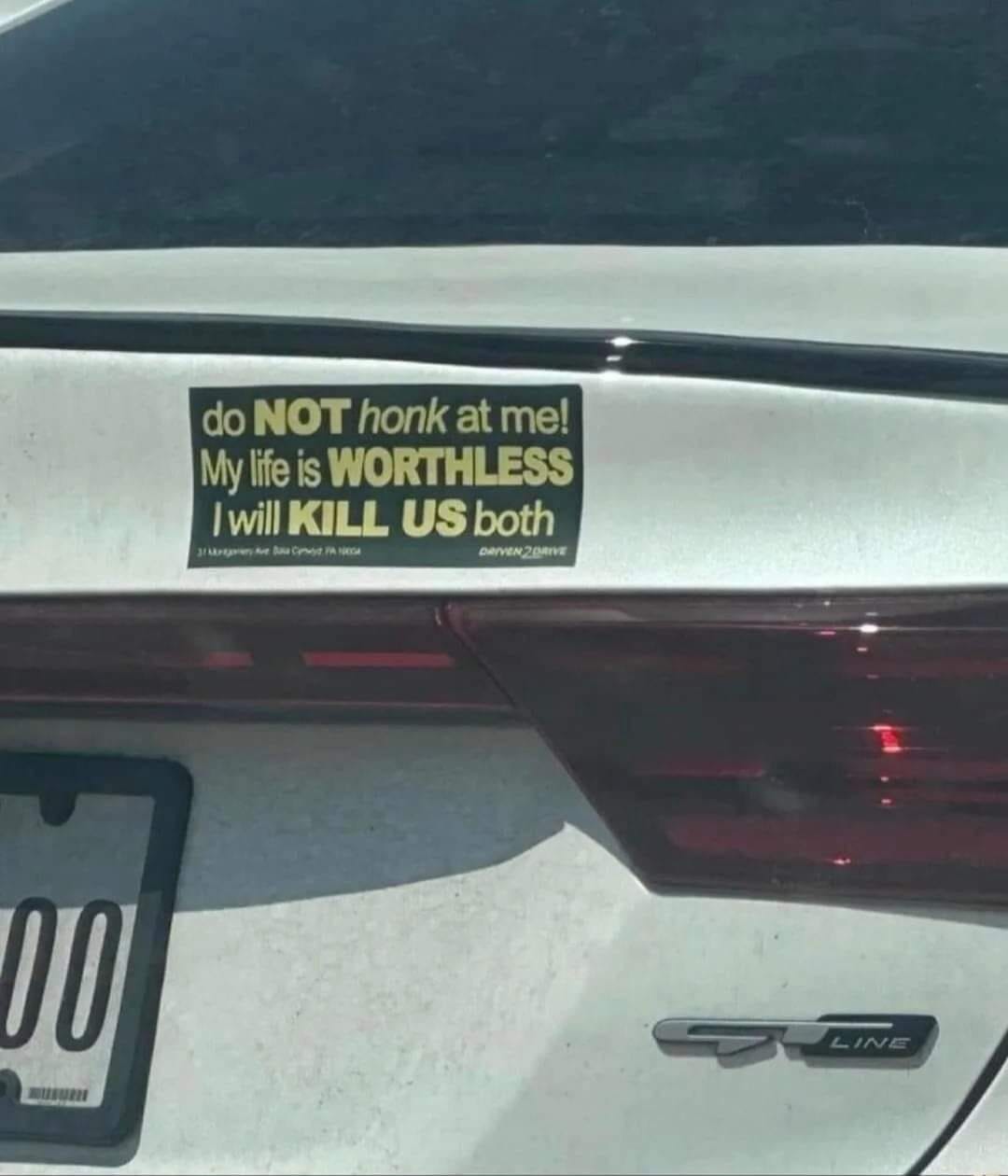This meme is a humorous image featuring a bumper sticker on a car. The sticker reads: "do NOT honk at me! My life is WORTHLESS I will KILL US both". The text is written in a bold, playful font, and the use of all capital letters adds to the humor. The image is likely intended to be ironic or sarcastic, poking fun at the idea of someone being so angry or upset that they would threaten to harm others.