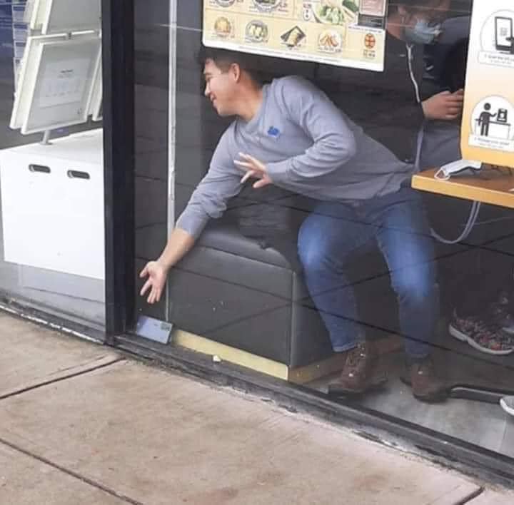 The meme is a photo of a person sitting on the floor of a restaurant, with their legs stretched out in front of them and their head resting on the table. The text "I've been sitting here for 10 minutes" appears on the screen of the person's phone, which is lying on the table in front of them. The meme is humorous because it pokes fun at the frustration of waiting for a table at a busy restaurant.