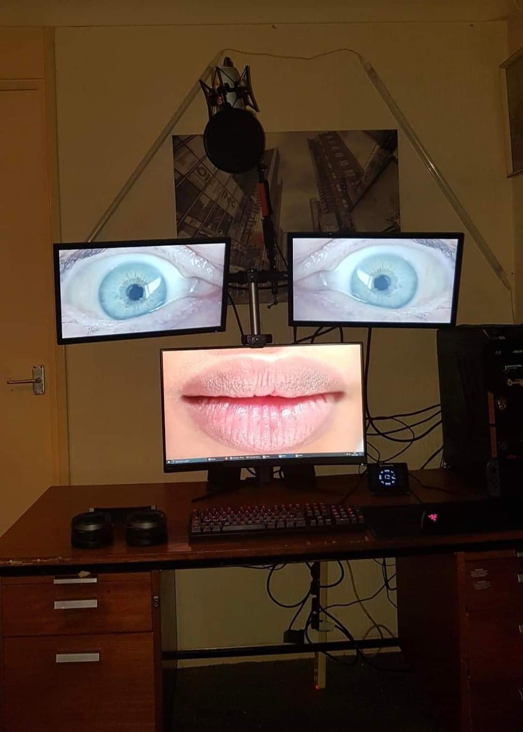 The meme is a screenshot of a computer desktop with multiple monitors displaying a close-up of a person's eye and a mouth. The text "I can see your eyes" is written on the screen, suggesting that the person is aware of being watched. The image is meant to be humorous and ironic, implying that someone is trying to be secretive but is actually being watched.