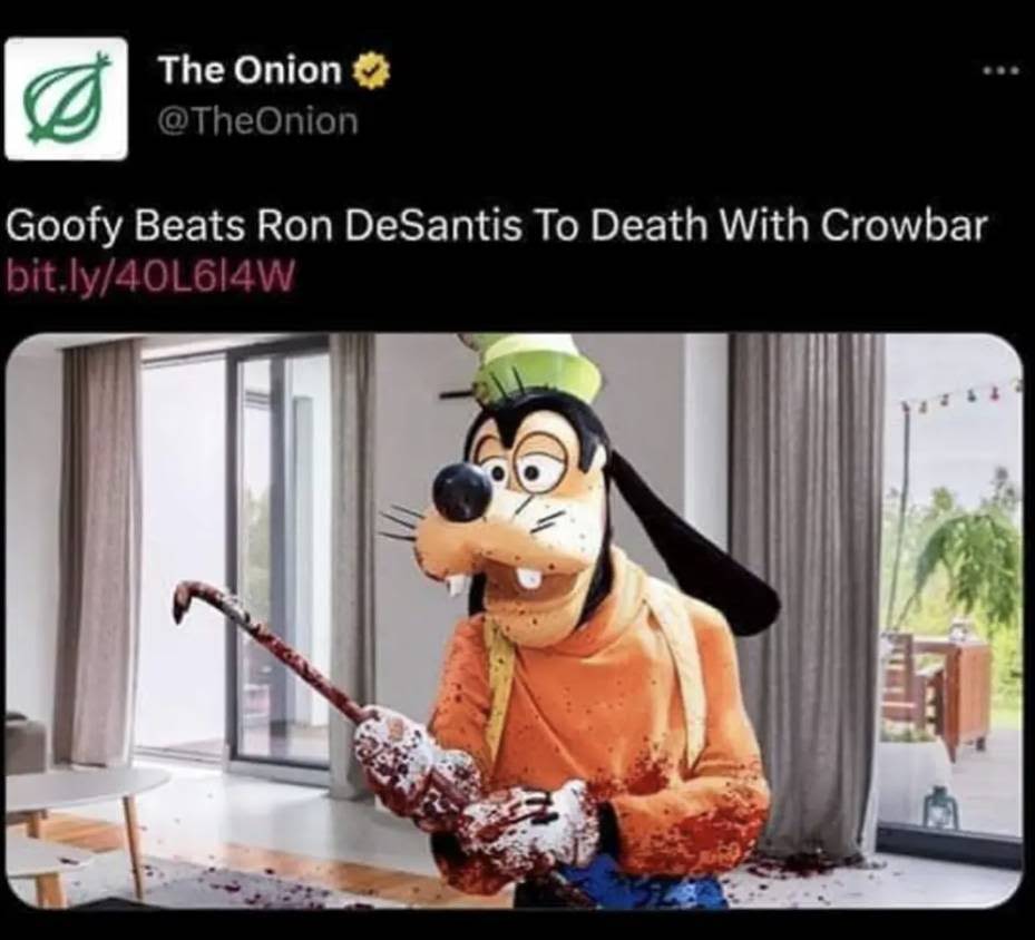 The meme is a humorous image of Goofy, the cartoon character, holding a blood-soaked axe and a trophy that says "I'm the real MVP". The text at the top of the image reads "Goofy beats Ron DeSantis to death with a crowbar". The image is a darkly comedic take on the idea of a cartoon character winning a brutal fight against a real-life politician.