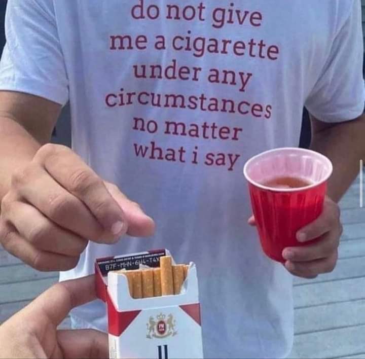 This meme features a person wearing a t-shirt with a humorous warning message. The text on the shirt reads: "do not give me a cigarette under any circumstances no matter what i say". The image is likely accompanied by a humorous or ironic situation, such as a person being offered a cigarette despite the warning.