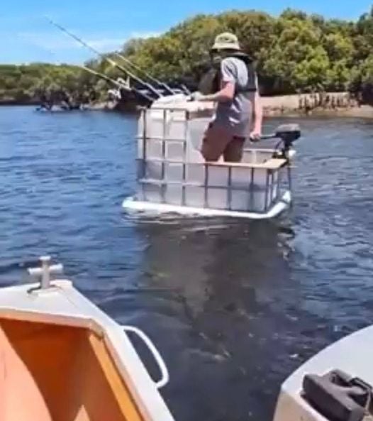 The meme depicts a person sitting in a makeshift boat made from a large plastic container, with a few fishing rods sticking out of it. The image is captioned "I've been fishing for 20 years, but I've never caught anything this big".