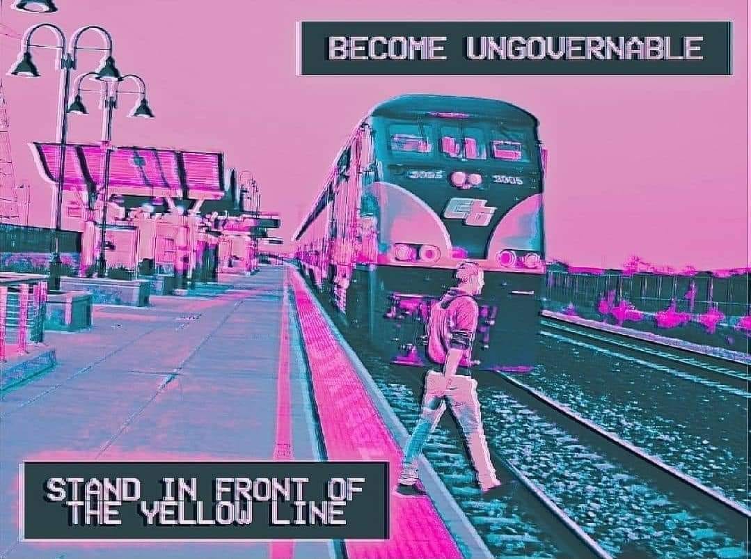 This meme is an image of a person standing in front of a train, with a bold warning sign reading "BEWARE OF TRAINS" above them. The text "STAND IN FRONT OF THE YELLOW LINE" is written in a similar style, implying that the person is ignoring a clear warning. The image is likely humorous because it's a clear warning sign, but the person is still ignoring it, making them "ungovernable" and likely to get hurt.