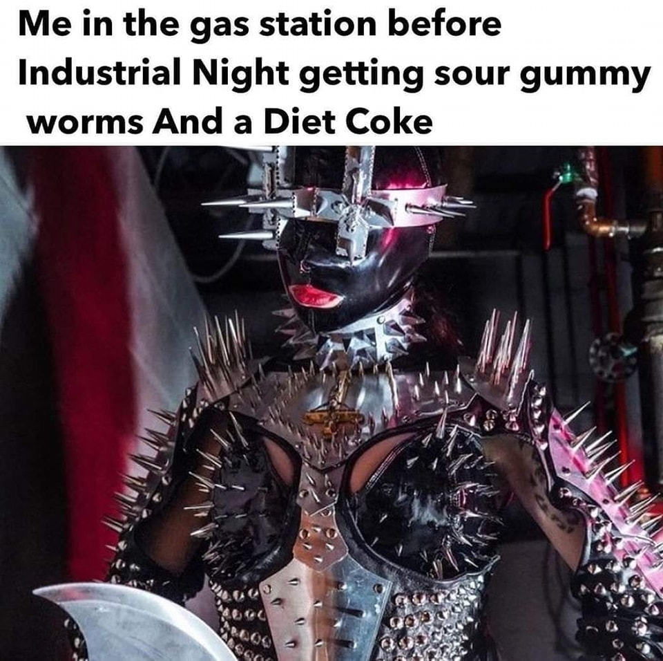 The meme is a humorous image featuring a person in a futuristic, high-tech exosuit, with a caption that contrasts their elaborate, high-tech appearance with their mundane, everyday activities. The text reads: "Me in the gas station before Industrial Night getting sour gummy worms and a Diet Coke." The image is likely meant to be humorous and ironic, poking fun at the contrast between the person's high-tech appearance and their low-key, everyday activities.