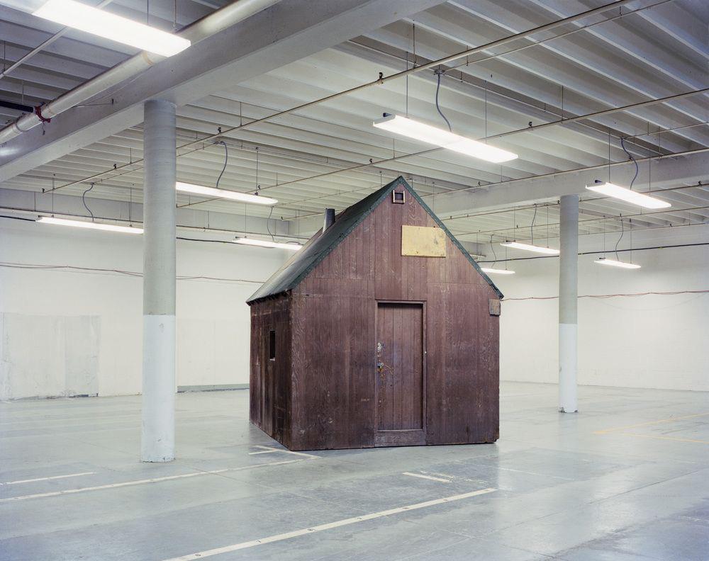 The meme features a photo of a small, empty house with a sign on the door that reads "Homeless". The image is often used to express that someone's life or situation is in a state of chaos or disarray, similar to the idea of being homeless despite having a physical home.