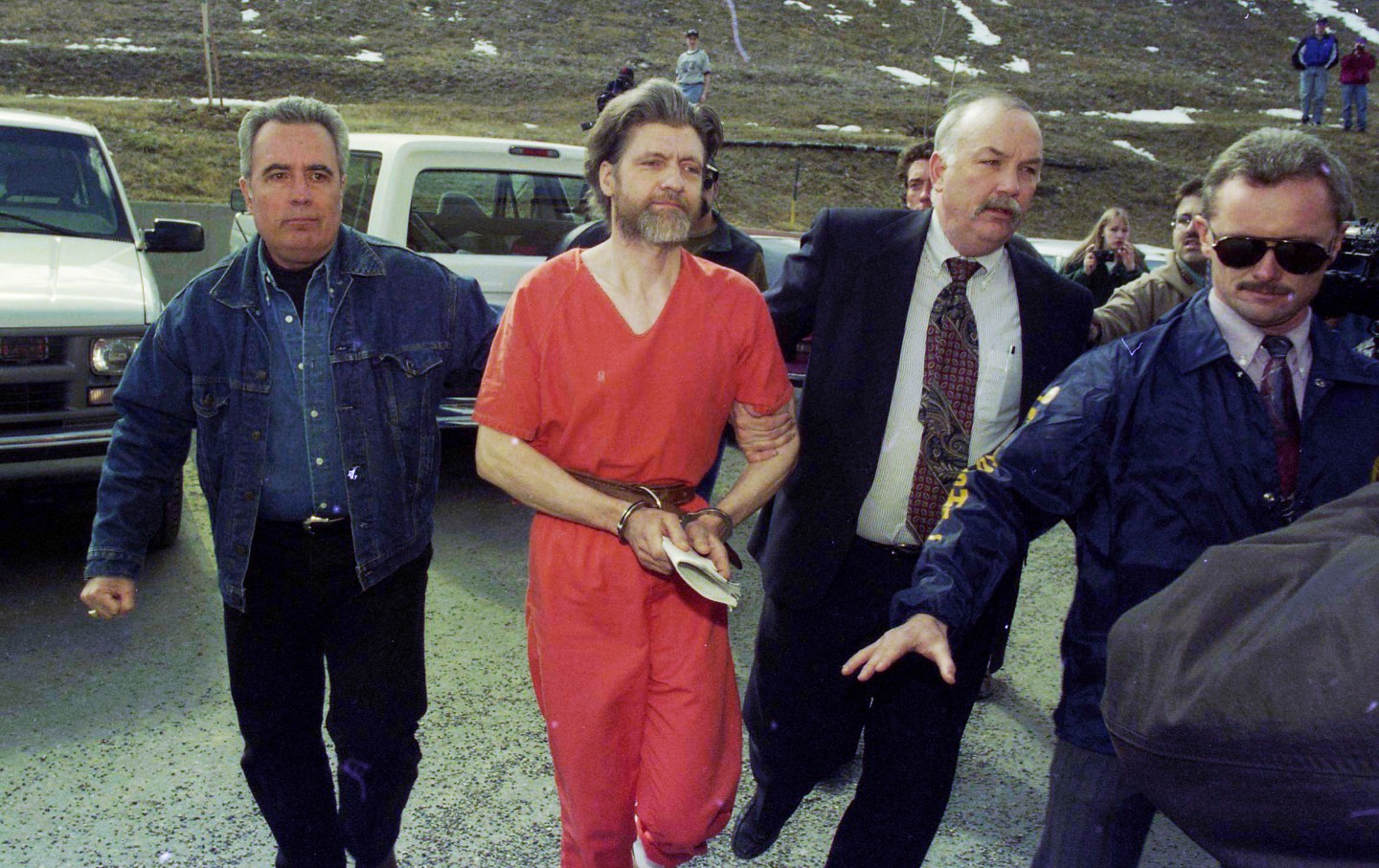 The meme is an image of Ted Kaczynski, also known as the Unabomber, being led away by police in handcuffs. The text in the image reads "when you're a 3 hour lecture on cabin life is 3 hours too long". The meme is a humorous take on the idea that even someone as notorious as the Unabomber can be annoying, even in a prison setting.