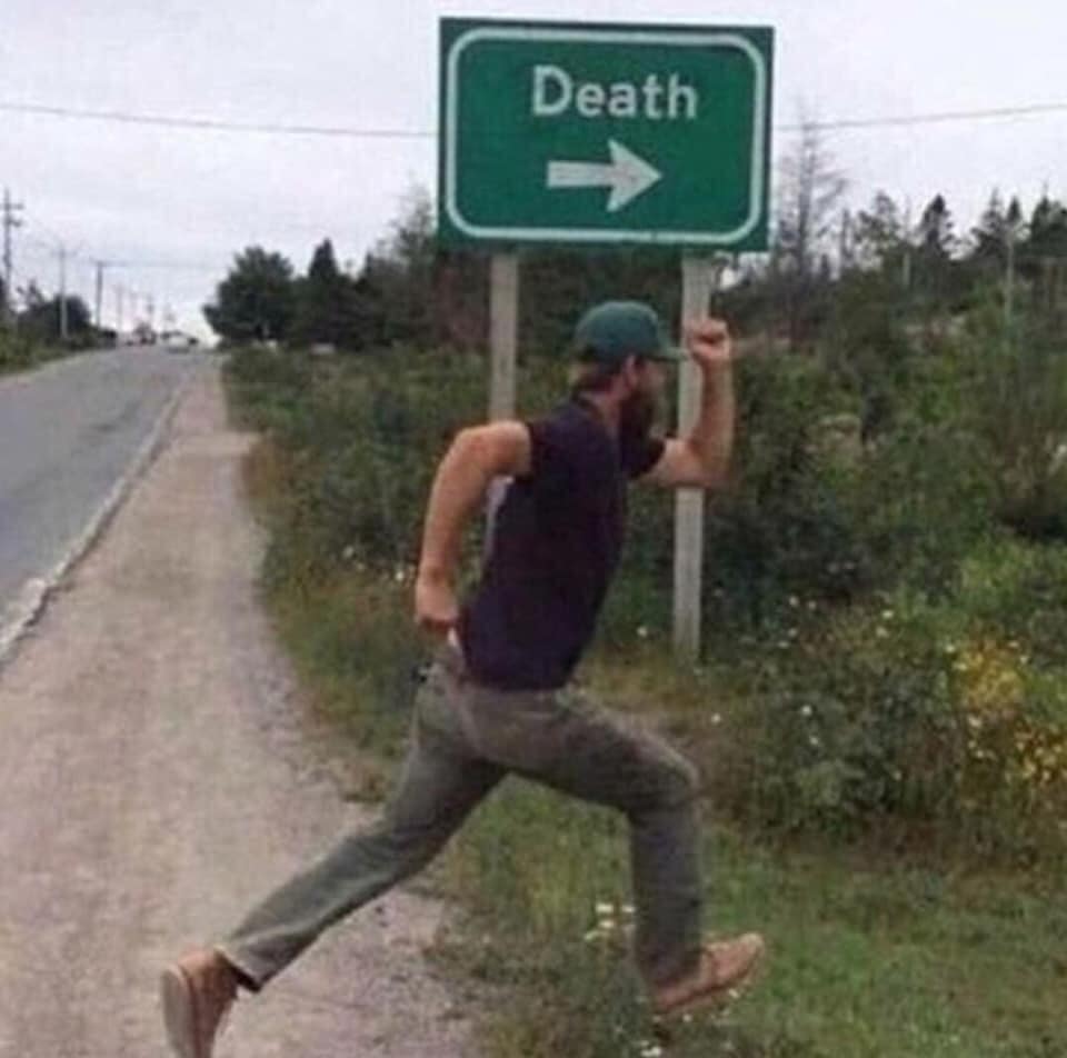 The meme is a photo of a person running away from a sign that says "Death" with an arrow pointing to the left. The person is depicted in a frantic and humorous pose, as if they're desperately trying to escape the sign's ominous warning. The image is likely meant to be humorous and ironic, poking fun at the idea of trying to avoid death.
