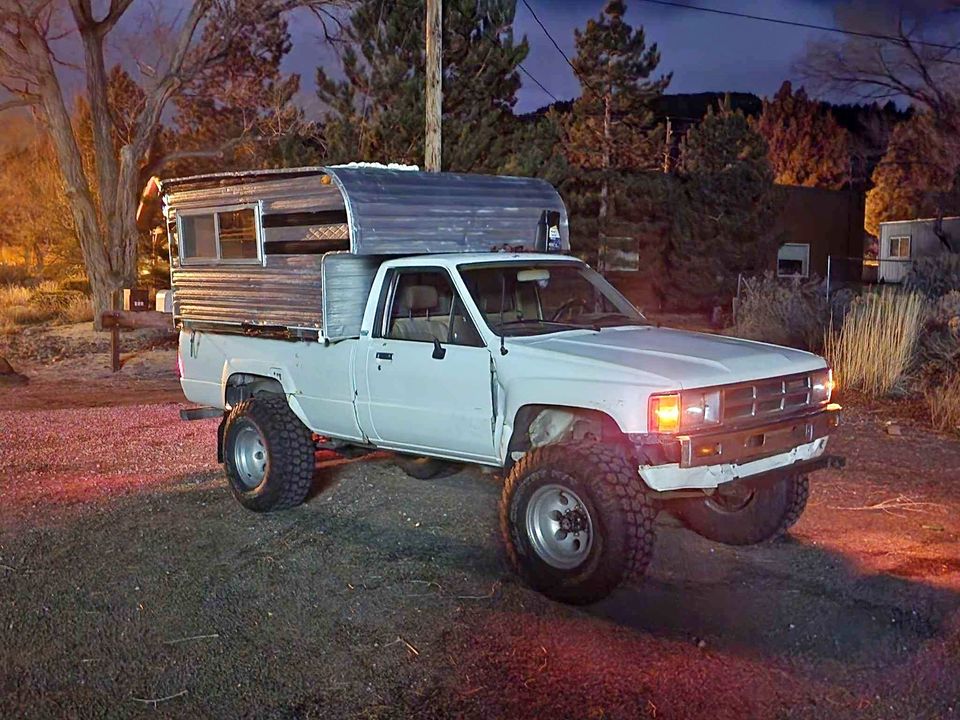 The meme is an image of a Toyota 4x4 pickup truck with a camper shell on the back. The camper shell is a small, rusty, and worn-out trailer that looks like it's been through a lot. The text that appears in the image is "I've been driving my truck for 20 years, I've been sleeping in it for 5".
